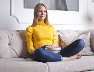 woman sitting on couch with popcorn